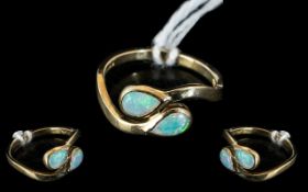 A 9ct Gold Opal Ring Set with Two Tear Shape Opals on a Twist fully hallmarked, ring size L.