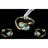 A 9ct Gold Opal Ring Set with Two Tear Shape Opals on a Twist fully hallmarked, ring size L.