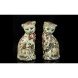 Pair of Matching Oriental Cats, 7" high, decorated with figures and flowers, marks to base.