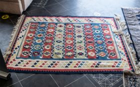 Middle Eastern Aztec Style Rug, in red, green, blue and cream with deep fringing.