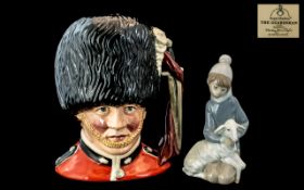 Royal Doulton 'The Guardsman' D6755, (second), 8'' tall, together with a Lladro figure of a boy