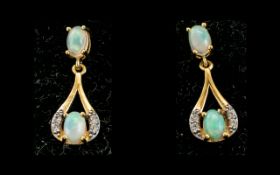 Opal Drop Earrings, each earring having a round cut opal cradled in a loop of gold vermeil and