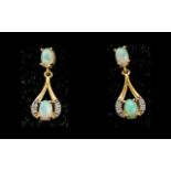 Opal Drop Earrings, each earring having a round cut opal cradled in a loop of gold vermeil and