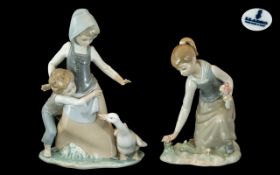 Two Lladro Figurines 'Girl Gathering Flowers' (#1172) 8 inches tall and 'Avoiding the Goose'