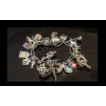 A Good Quality Vintage Sterling Silver Charm Bracelet, Loaded with 25 Silver Charms.