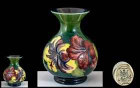 Moorcroft 'Hibiscus' Pattern Vase, 5.5" tall, dark green background with floral pattern.