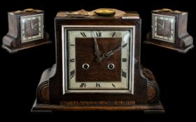 An Oak Cased Art Deco Mantle Clock with square chapter dial and Roman numerals, height 9",