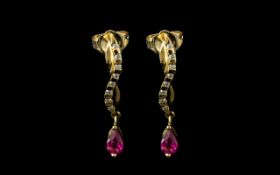 18ct Diamond And Ruby Earrings Each Set With Eight Round Cut Diamonds With A Ruby Drop.