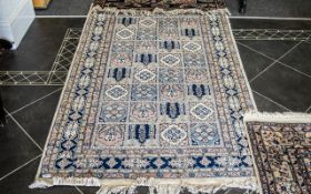 Middle Eastern Rug in tile style relief in blue cream and pink with fringing.