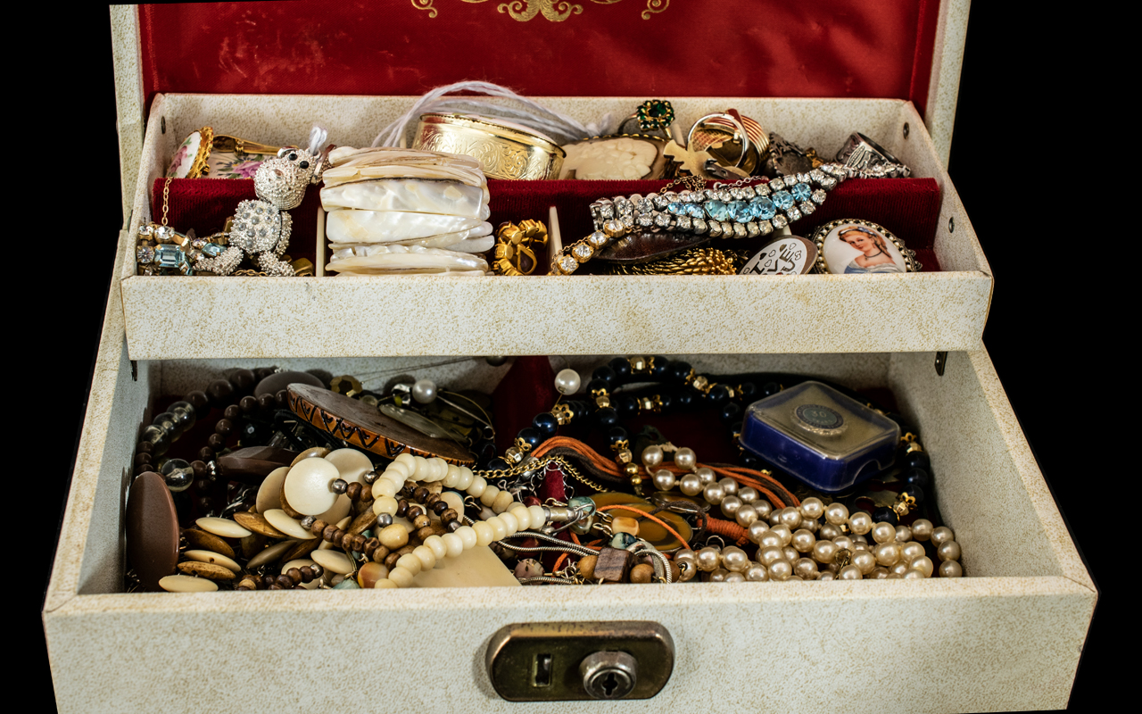 Collection of Costume Jewellery, housed in a two tier cream jewellery box, including brooches,