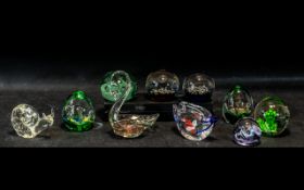 Collection of Ten Glass Paperweights, comprising a swan with two goldfish, a purple sphere,