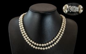 Two Quality Pearl Necklaces, a twin strand necklace with a diamonte clasp, 20" length,