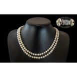 Two Quality Pearl Necklaces, a twin strand necklace with a diamonte clasp, 20" length,