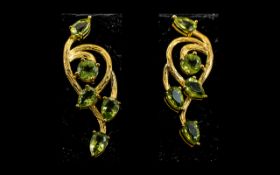 Peridot Art Nouveau Style Long Drop Earrings, each earring having five pear and round cut