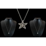 18ct White Gold Diamond Set Star Pendant with Attached 18ct White Gold Chain.