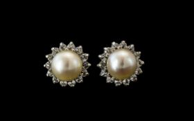 An 18ct White Gold Pearl And Diamond Stud Earrings With Screw Backs. Central Pearls 7.