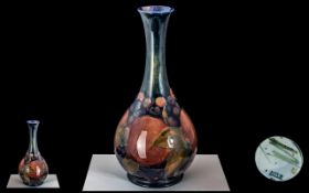 William Moorcroft Signed Bulbous Shaped Vase ' Pomegranates ' Design on Blue Ground. c.1930's.