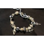 Pandora Style Charm Bracelet, in a Pandora box, filled with charms including dice, starfish, high