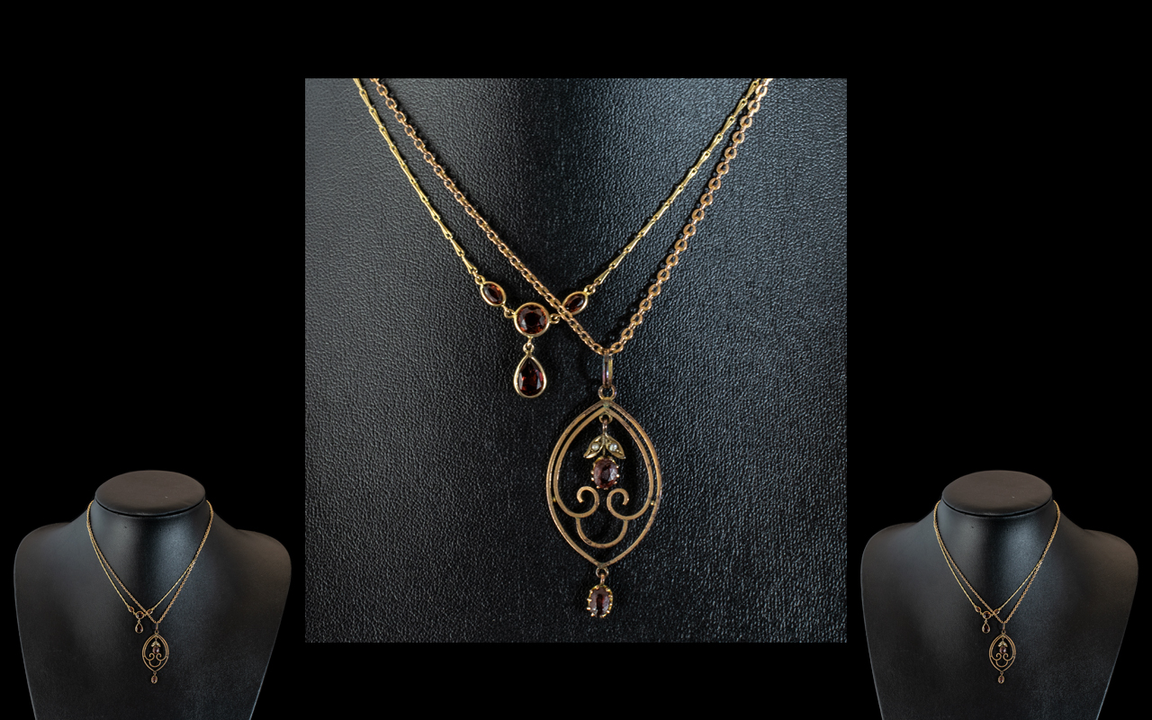 A 9ct Gold Edwardian Pendant Two Pearls and Two Faceted Red Stones suspended on a 9ct gold fine