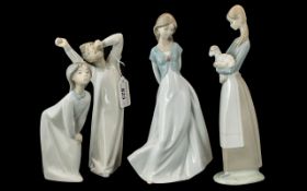 Collection of Three Lladro Figures, comprising Yawning Boy 8.5" tall, Goodnight Kiss 7.