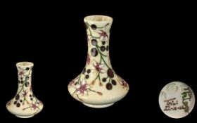 Small Moorcroft Trial Vase No. T/DTEM62/4 Winter Rose pattern, height 4.25".