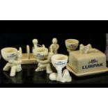Collection of Lurpak Kitchen Ware, comprising a toast rack, butter dish and four egg cups.