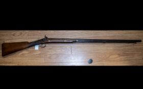 A 19th Century Percussion Riffle with walnut stock, appears unmarked. Overall length 51 inches.