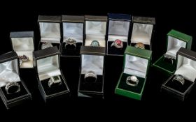 Collection of Twelve Silver Dress Rings, set with coloured crystals, stones, pearls, etc.