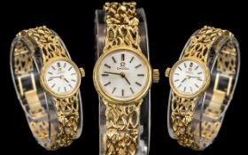 Omega - Elegant Ladies 9ct Gold Wrist Watch, With Integral Open worked Design 9ct Gold Bracelet.