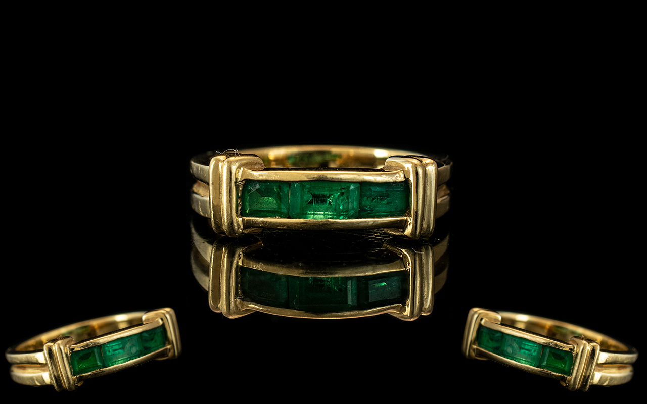 An 18ct Gold Emerald Ring Three channel