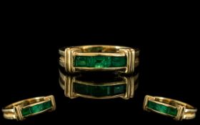 An 18ct Gold Emerald Ring Three channel