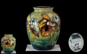 William Moorcroft Signed Hand Painted Ovoid Shaped Vase ' Orchids ' Design on Green / Blue Ground.