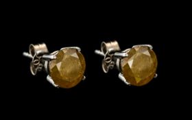 A Pair Of 18ct White Gold Diamond Stud Earrings. Each Stone Set With An Opaque Fancy Yellow Coloured