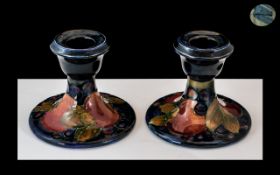 William Moorcroft Signed Pair of Squat Candlesticks In the ' Pomegranates ' Design on Blue Ground.