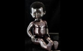 Vintage Black Baby Doll, moving limbs and open and shut eyes, with black curly Afro hair.