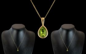 Ladies 9ct Gold - Mounted Pear Shaped Peridot Pendant Attached to a 9ct Gold Chain.