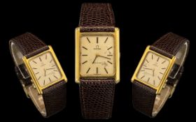 Omega - Deville Slim line Gold Plated Wrist Watch of Rectangular Form with Attached Leather Strap.
