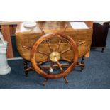 Ship's Wheel, a large brass mounted teak eight-spoke ship's wheel. 30" diameter.