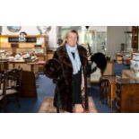 Ladies Quality Mink Coat with leather side panels, sleeve panels, and tie belt.