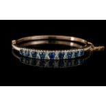 Antique Period 9ct Rose Gold Hinged Bangle Set with Cornflower Blue Sapphires with Diamond Spacers.