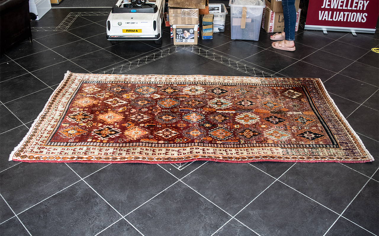 Wool Rug, geometric design, mainly beige and rust/orange colours, fringe edges, border pattern.