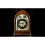 A Gustav Becker Mahogany Mantle Clock gilt chapter dial with Roman Numerals on a silvered dial.