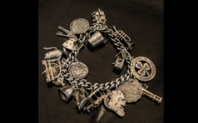 A Vintage - Sterling Silver Charm Bracelet - Loaded with 18 Silver Charms. All Marked for Silver.