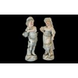 A Pair of Bisque Figures of a Boy and Gi