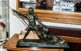 Large Art Deco Green Patinated Spelter Figural Group, a hunter with a spear with an attacking