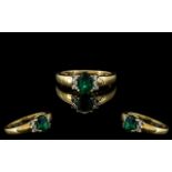 9ct Gold Diamond & Green Stone Dress Ring, oval cut green faceted stone set between brilliant cut