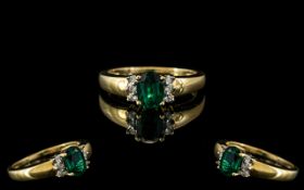 9ct Gold Diamond & Green Stone Dress Ring, oval cut green faceted stone set between brilliant cut