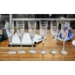 Six Tall Glass Champagne Flutes, with floral etching to top and star cut glass bowl, raised on a