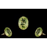 Ladies - Large and Impressive 9ct Gold Peridot Set Ring. The Large Faceted Pale Green Peridot of
