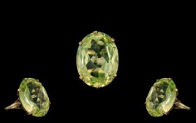 Ladies - Large and Impressive 9ct Gold Peridot Set Ring. The Large Faceted Pale Green Peridot of